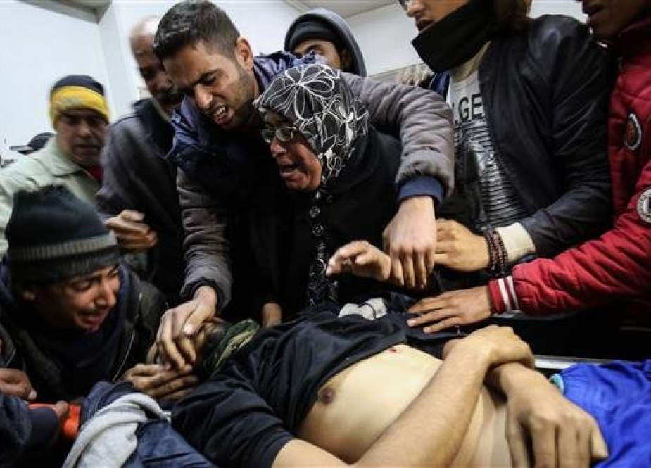 The mother, center, and relatives of Ihab Atallah Hussein Abed, 25, react as they identify his body at a hospital in Rafah in the southern Gaza Strip on January 25, 2019. (Photo by AFP)