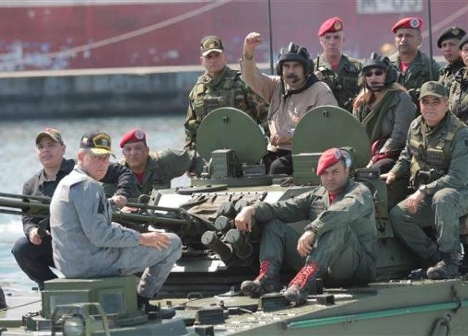Venezuelan President Nicolas Maduro (C-L) is seen atop a military vehicle during a military exercise in Puerto Cabello, January 27, 2019. (Photo by Reuters)