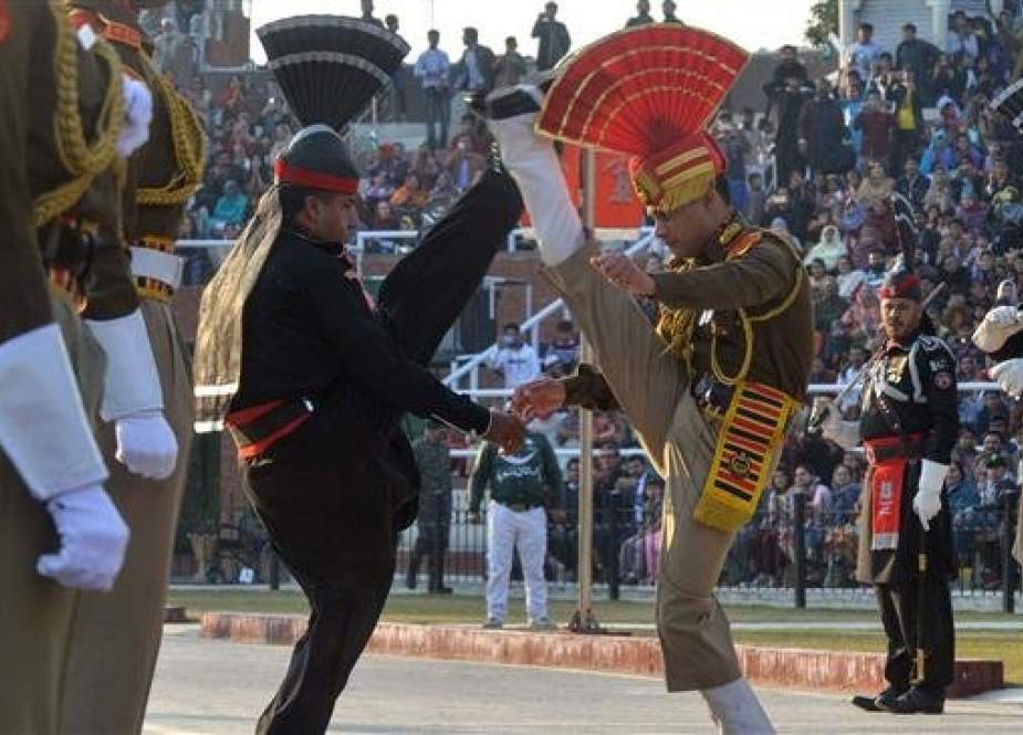Indian Border Security Force (BSF) personnel wearing brown uniforms and Pakistani Rangers wearing black uniforms perform while they take part in the Beating Retreat ceremony during the Republic Day celebrations at the India-Pakistan Wagah border post, some 35 kms from Amritsar, on January 26, 2019. (Photo by AFP)