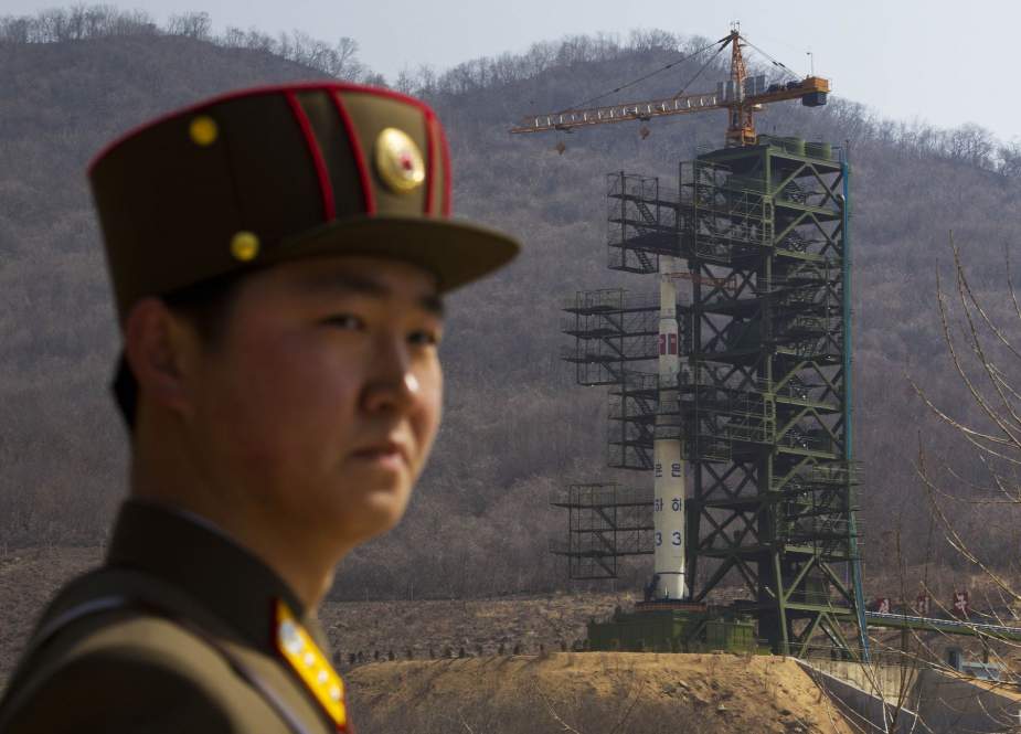 A North Korean soldier stands guard in front of a Unha-3 rocket at the Sohae Satellite Launch Station in Tongchang-ri.