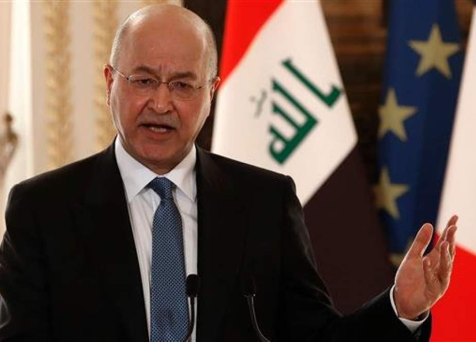 This file photo shows Iraqi President Barham Salih gesturing during a press conference. (Photo by AFP)