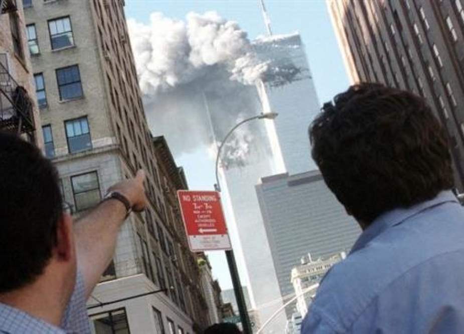 Pedestrians react to the World Trade Center attacks in New York, on September 11, 2001. (Photo by Reuters)