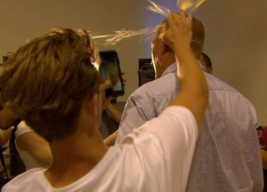 This photo from a video grab apparently shows Will Connoly putting a raw egg on the side of Senator Fraser Anning