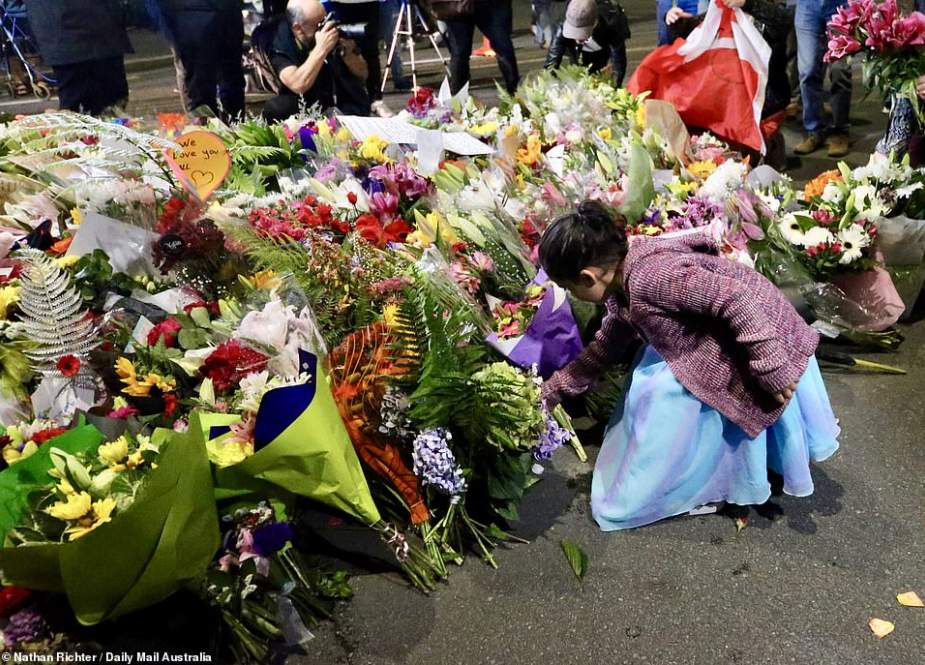 Floral tributes to those who were gunned down at the two mosques are seen against a wall bordering the Botanical Garden in Christchurch on March 19, 2019.