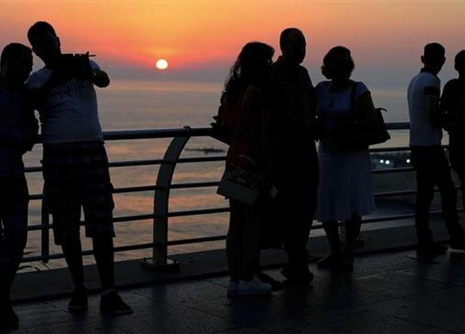 In this picture taken on June 30, 2017, tourists take pictures as the sun sets over the Mediterranean Sea in Beirut, Lebanon. (Photo by The Associated Press)