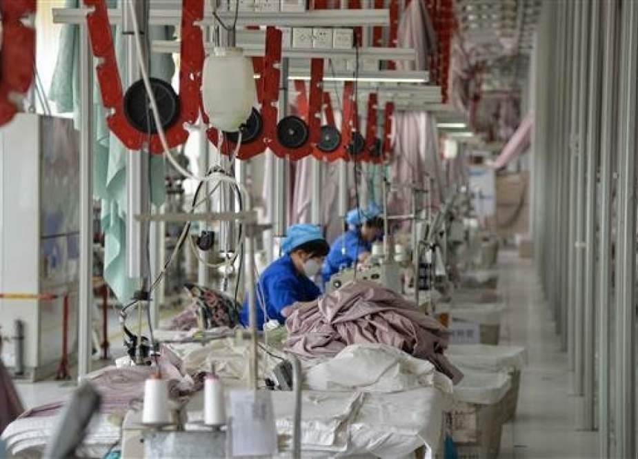Chinese employees work on manufacturing products that will be exported to the US at a factory in Binzhou in China