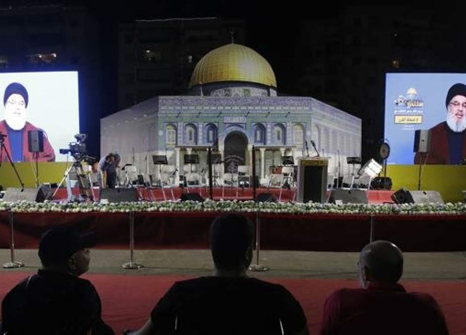Lebanese Shia Muslims listen to a speech by the head of the Lebanese resistance movement Hezbollah, Sayyed Hassan Nasrallah, transmitted on two large screens with a replica of the Dome of the Rock mosque, in a southern suburb of the capital Beirut on May 31, 2019. (Photo by AFP)