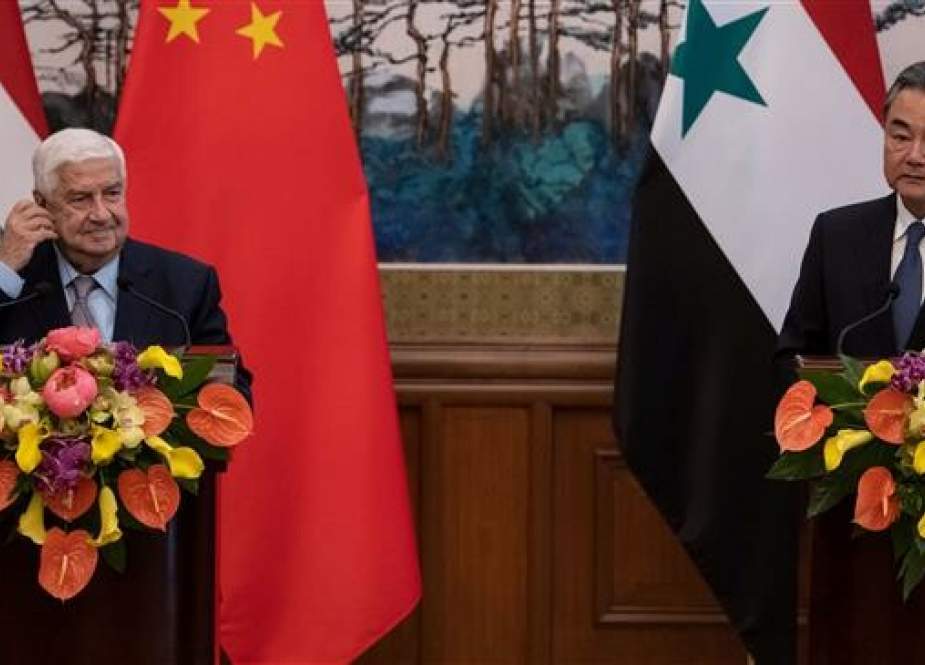 Chinese State Councilor Wang Yi (R) and Syrian Foreign Minister Walid Muallem attend a press conference after a meeting in Beijing on June 18, 2019. (Photo by Reuters)