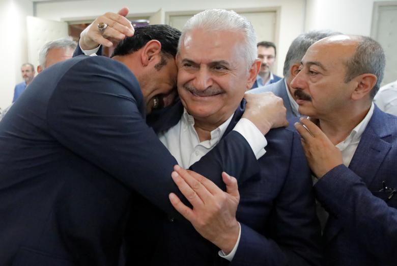 Binali Yildirim, mayoral candidate of the ruling AK Party, is greeted by a supporter at his party's Istanbul headquarters in Istanbul, June 23