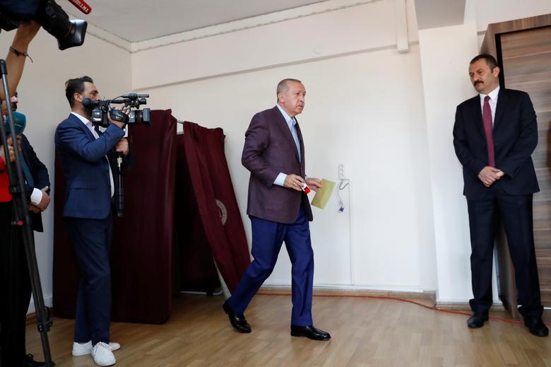 Turkish President Tayyip Erdogan leaves a voting booth before casting his ballot, at a polling station in Istanbul, June 23