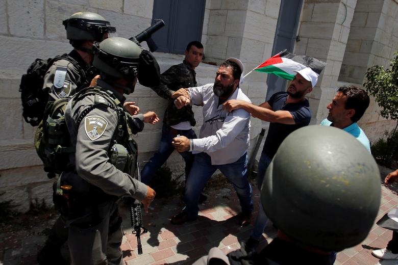 A Palestinian demonstrator scuffles with Israeli forces during a protest against Bahrain's workshop for U.S. peace plan, in Bethlehem, in the Israeli-occupied West Bank June 25