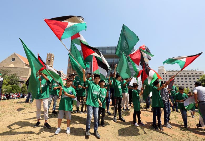 Demonstrators hold Palestinian flags as they take part in a protest against Bahrain's conference about U.S. President Donald Trump's vision for Mideast peace plan, in front of the U.N. headquarters, in Beirut, Lebanon, June 25