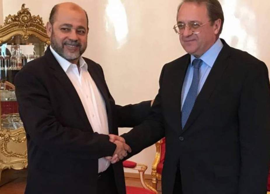 Russia’s Deputy Foreign Minister Mikhail Bogdanov (R) shakes hands with Hamas official Mousa Abu Marzook