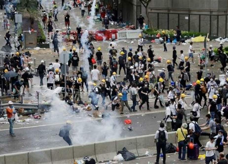 Riot police fire tear gas to protesters outside the Legislative Council in Hong Kong.jpg