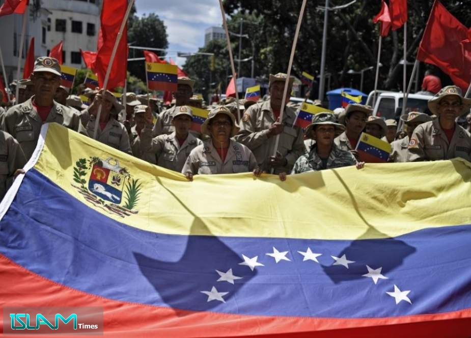 Venezuelan protesters rally against US sanctions with a national flag in Caracas