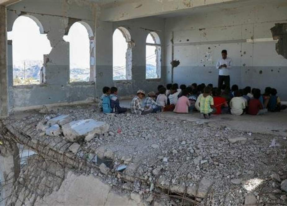 Yemeni children attend class on the first day of the new academic year in the city of Ta