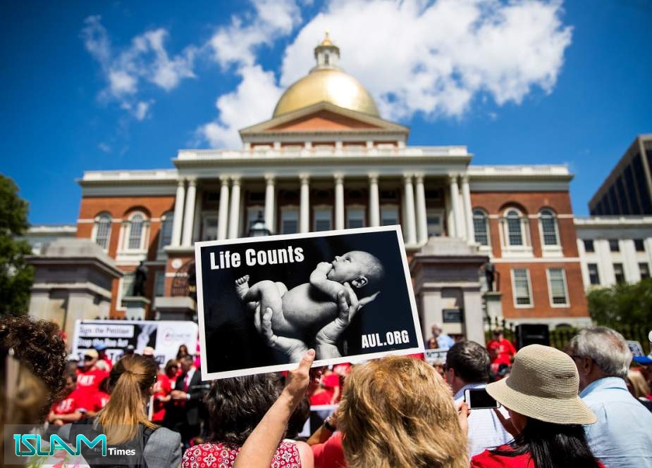 Supporters of Massachusetts Citizens for Life hold during a rally outside the Massachusetts Statehouse