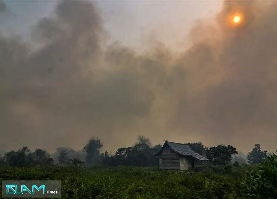 Thick smoke from a forest fire nearly covers the sun over Pekanbaru in Riau Province, Indonesia, on September 18, 2019.