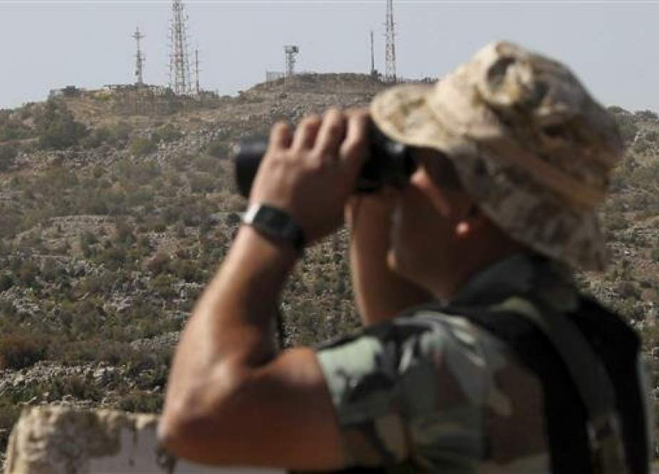 Israeli army position looks over a Lebanese army soldier in the Kfar Shuba hills.jpg