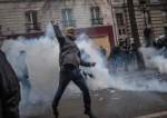 A protestor throws a tear gas canister back to the police during a protest rally in Paris, on December 5, 2019. (Photo by AFP)
