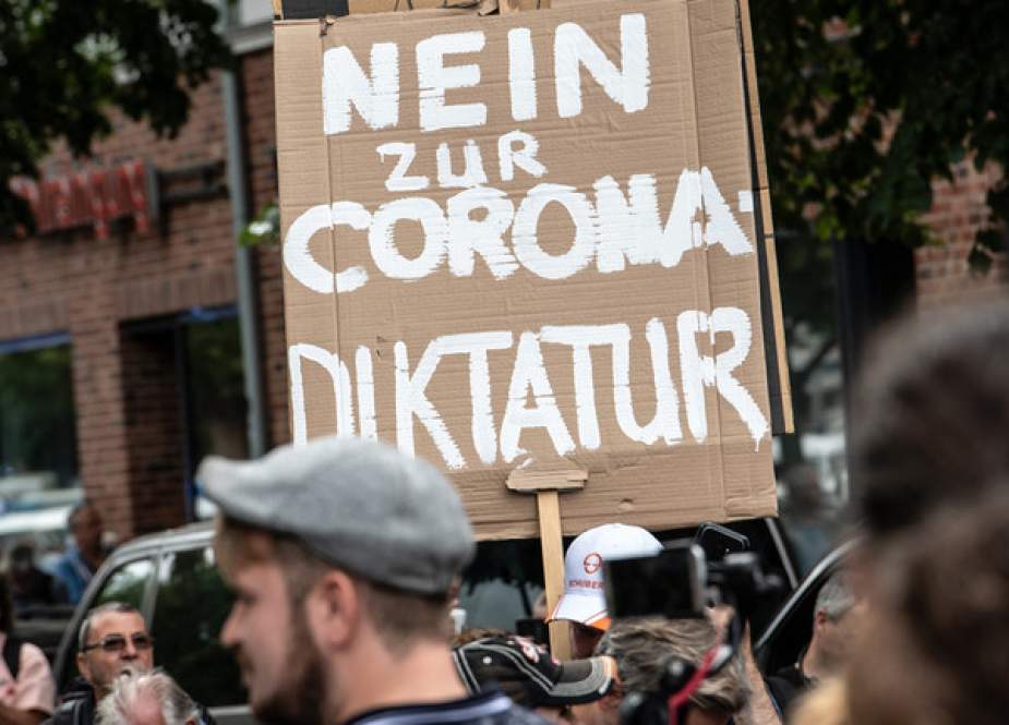 Protesters march with a placard reading, ‘No to the Corona dictatorship’, in Berlin, Germany,.jpg