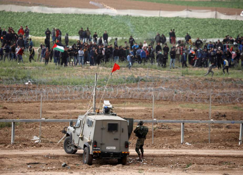 Israeli soldiers clash with Palestinian protestors over the border fence between Israel and the Gaza Strip.JPG