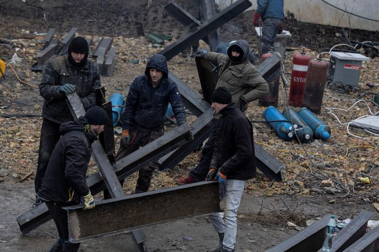 Workers from a local construction company weld anti-tank obstacles to be placed around Kyiv, Ukraine, March 3.