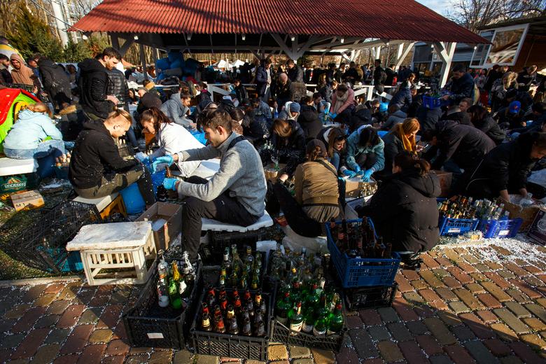 Local residents prepare Molotov cocktails to defend the city, in Uzhhorod, Ukraine February 27.