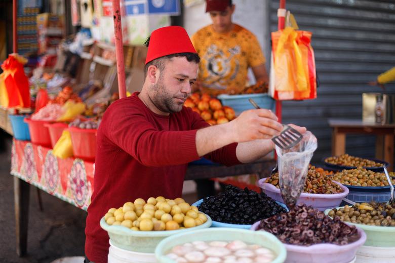 A Palestinian vendor sells olives and pickles in a market during the holy fasting month of Ramadan, amid a rise in prices as a result of the Russian invasion of Ukraine, in Khan Younis, in the southern Gaza Strip, April 4.