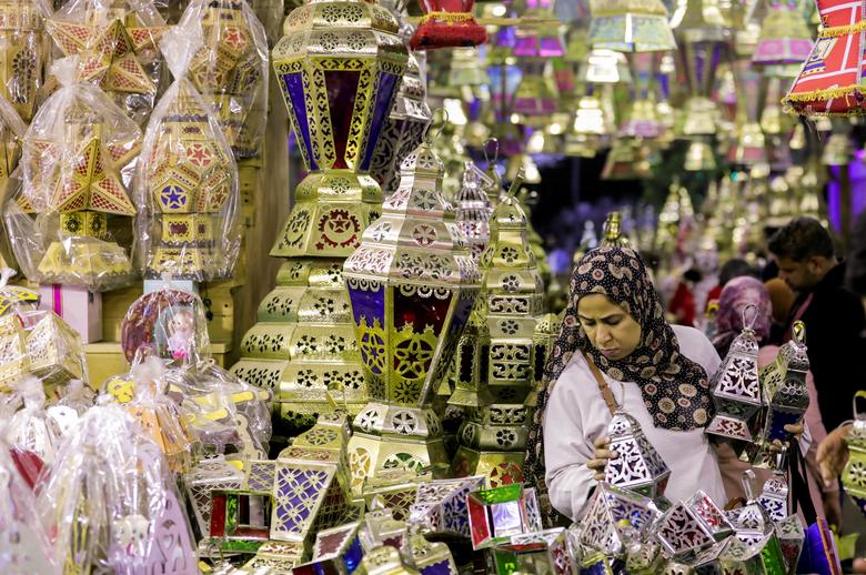 A woman checks a traditional Ramadan lantern, called 