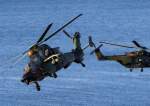 French Tiger attack helicopter together with French NH90 transport helicopter fly during a Joint demonstration as part of the NATO exercise.