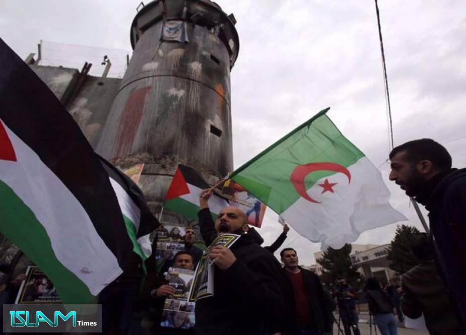 Palestinian protesters chant slogans and wave the national flag and the Algerian flag during a demonstration in Bethlehem, the Israeli-occupied West Bank, following the weekly Muslim Friday prayers.