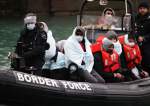 Migrants arrive into the Port of Dover onboard a Border Force vessel after being rescued while crossing the English Channel, in Dover, Britain, December 17, 2021.