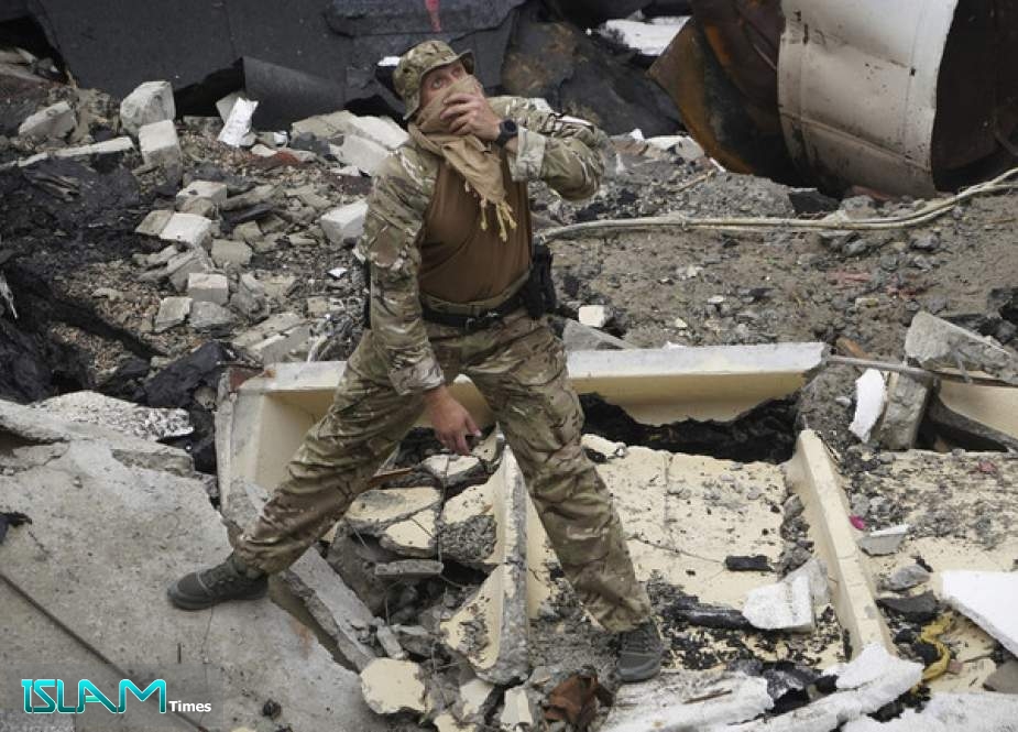 A Ukrainian serviceman examining a destroyed building