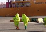 Jordanian civil defense teams in hazmat suits rush to an area at Aqaba port following a toxic gas leak.