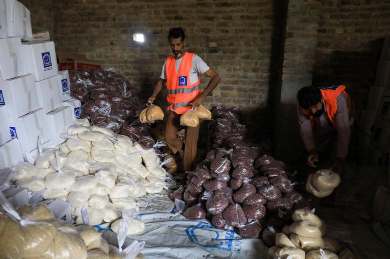 Volunteers prepare food packs to distribute among the flood victims, following rains and floods during the monsoon season in Peshawar, Pakistan August 26.