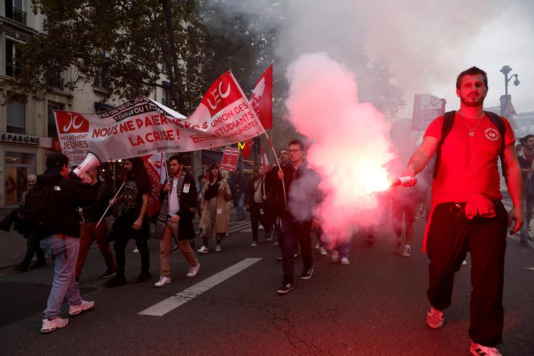 Protestors attend a demonstration in Paris as part of a nationwide day of strike and protests in France, October 18. The slogan reads 