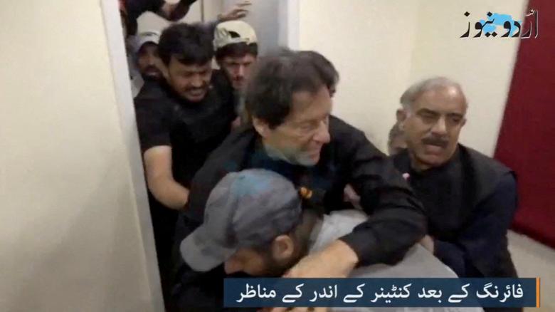 Former Pakistani Prime Minister Imran Khan is helped after he was shot in the shin in Wazirabad, Pakistan November 3, 2022 in this still image obtained from video.