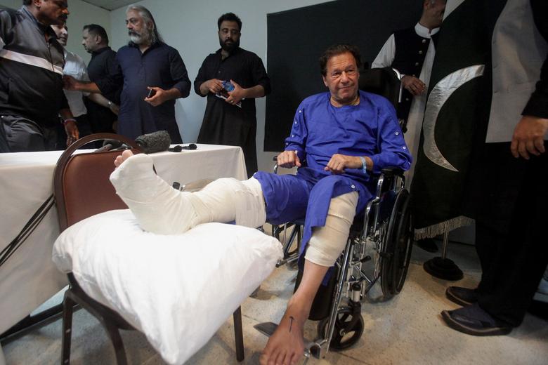 Former Pakistan's Prime Minister Imran Khan sits in a wheelchair after he was wounded following a shooting incident on a long march in Wazirabad, at the Shaukat Khanum Memorial Cancer Hospital & Research Centre in Lahore, Pakistan November 4, 2022.