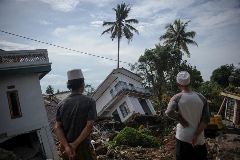 Islamic students look at houses collapsed during Monday's earthquake in Cianjur, West Java province, Indonesia, November 23, 2022.