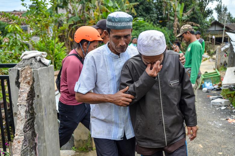 A man cries before the funeral of his child who was found dead after Monday's earthquake in Cianjur, West Java province, Indonesia, November 25, 2022.