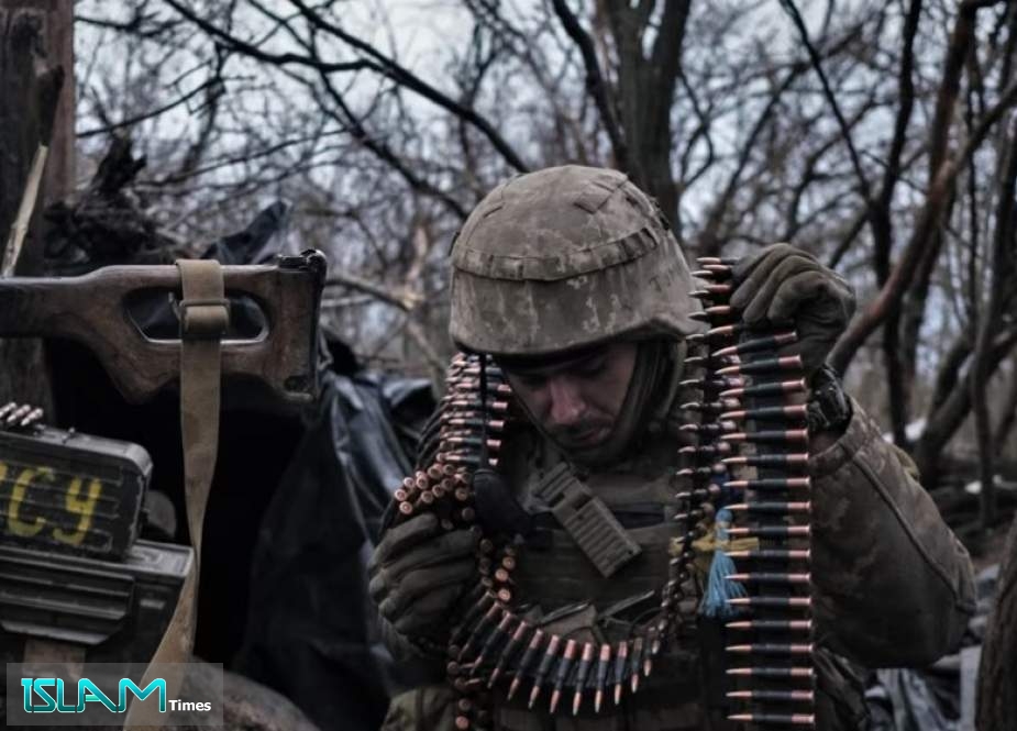 A Ukrainian soldier prepares ammunition to fire at Russian front-line positions near Bakhmut, in Donetsk region.