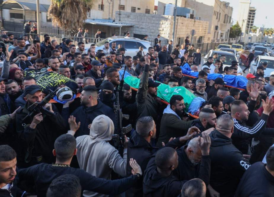 People attend the funeral procession of four Palestinians