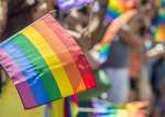 Rainbow Flag With Crowd In Background During Parade