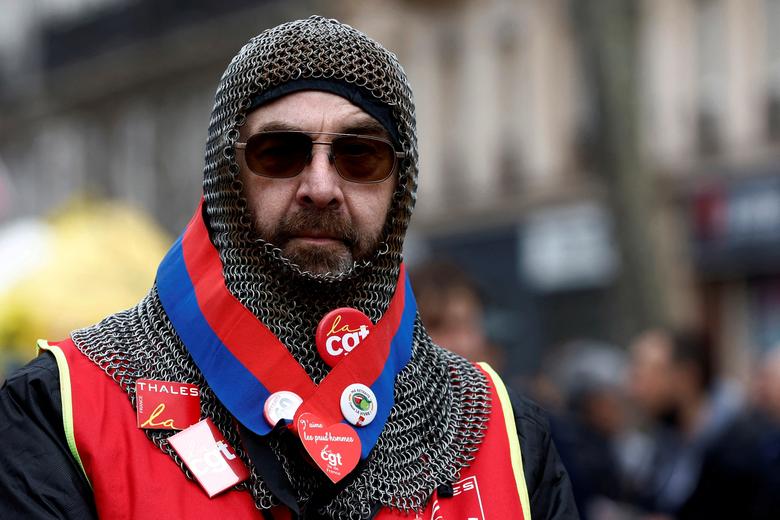 A protester, wearing a medieval combat hood, attends a demonstration against French government's pension reform, in Paris, France, March 23.  REUTERS/Gonzalo Fuentes