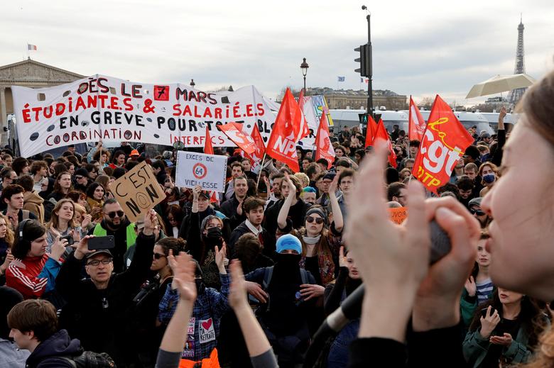 Demonstrators gather near the National Assembly to protest after French Prime Minister Elisabeth Borne delivered a speech to announce the use of the article 49.3, a special clause in the French Constitution, to push the pensions reform bill through the l