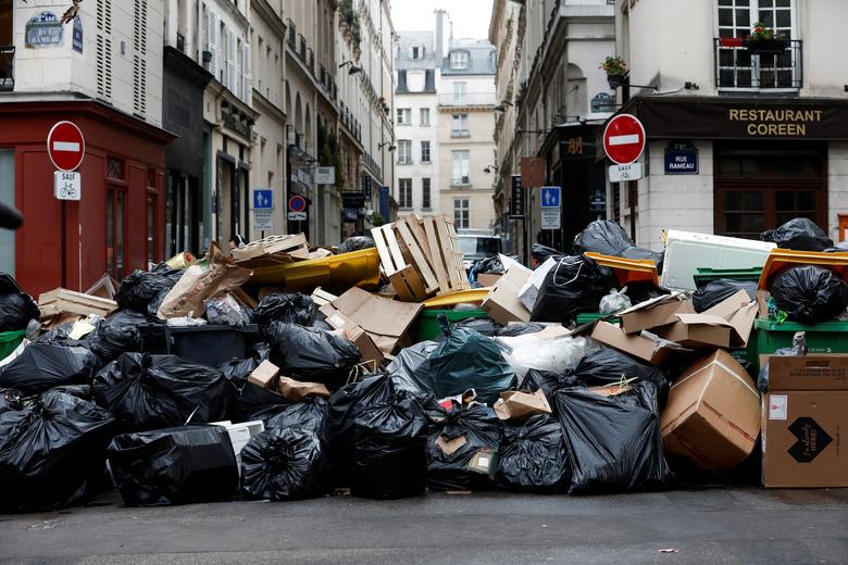 A view of a street where garbage cans are overflowing, as garbage has not been collected, in Paris, France, March 13. REUTERS/Benoit Tessier