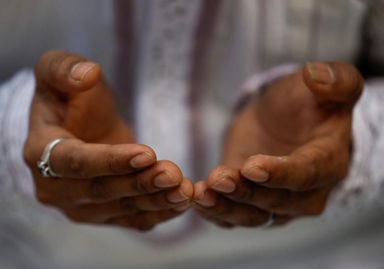 The hands of a Muslim man are pictured as he offers prayers during the Muslim holy month of Ramadan in Kathmandu, Nepal March 24, 2023.