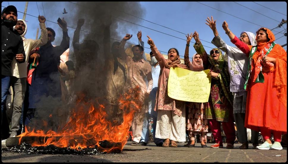 Imran Khan supporters chant slogans next to burning tires during a protest to condemn the arrest of their leader, in Hyderabad, Pakistan, May 09, 2023