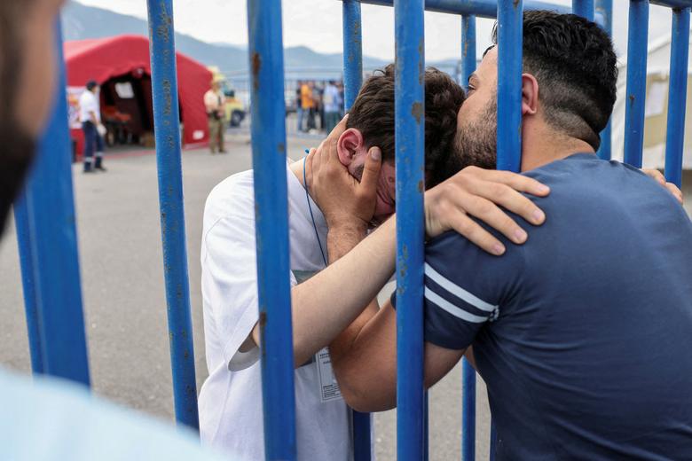 Syrian survivor Mohammad, 18, who was rescued with other refugees and migrants in the open sea off Greece after their boat capsized, hugs his brother Fadi, who came to meet him from Netherlands, as they reunite at the port of Kalamata, Greece, June 16.